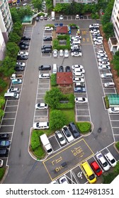 This Is An Apartment Parking Lot. It's Taken From A High Spot, And The Yellow Letter At The Bottom Says, 