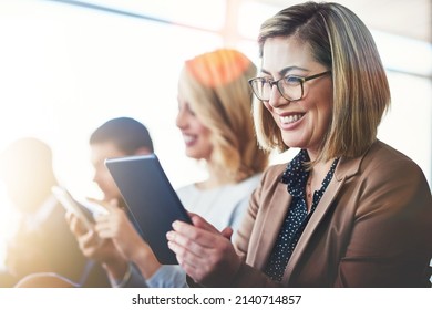 This App Is So Helpful In Meetings. Cropped Shot Of A Woman Using Her Digital Tablet While Sitting In A Meeting.