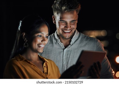 This App Is Perfect For What We Need. Shot Of Two Businesspeople Using A Digital Tablet Together Outside An Office At Night.