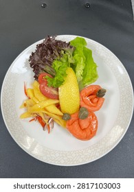 This appears to be a cold smoked salmon appetizer salad plated in a finedining or airline catering style.