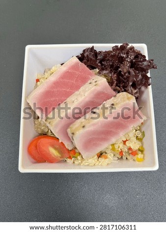 This appears to be a cold tuna tataki salad plated in a finedining or airline catering style