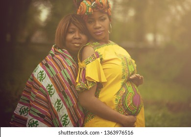 This Baby Is Our Happiness. African American Pregnant Woman In The Park With Her Mother.