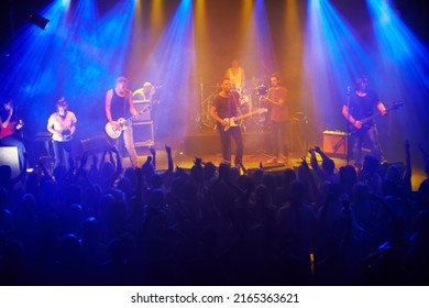 This Band Always Delivers. Shot Of A Large Crowd At A Music Concert- This Concert Was Created For The Sole Purpose Of This Photo Shoot, Featuring 300 Models And 3 Live Bands. All People In This Shoot