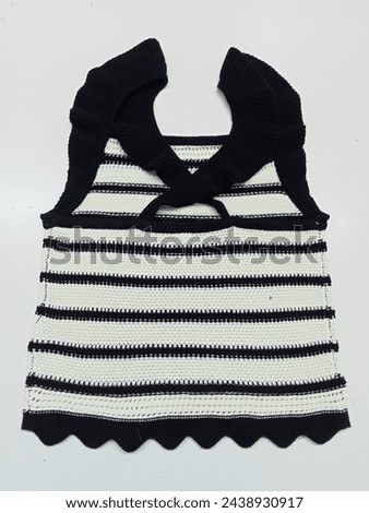 This beautiful black and white camisole with background is an attractive wear for kids and adult girls. It creates a clear, beauty picture with the addition of bright colors.
