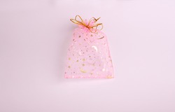 This Is A Beautiful Gift Of Transparent Pink And Gold Color Empty Voile Packing Bag On A Pink Background. Suitable For Packaging Jewelry, Cosmetics, Small Gifts And Surprises.