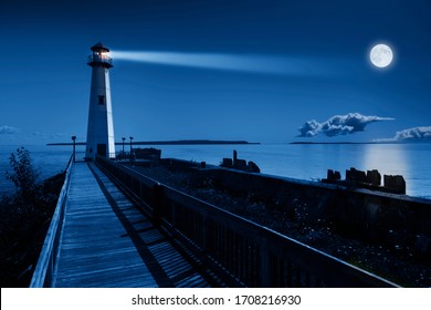 This Is A Beautiful Photo Illustration Of A Dramatic Night Time Scene With A Large Blue Moonrise In A Clear Sky On A Ocean Pier With A Brightly Lit Lighthouse Beacon And Calm Ocean Waters. 