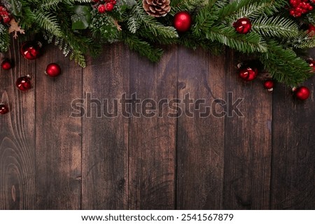  This beautiful rustic Christmas backdrop features a charming display of bright red ornaments and rich pine branches against a textured dark wood background, perfect for festive-themed designs. 