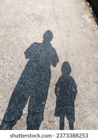 This beautiful shadow is created by facing away from the direction of the setting sun in the evening, and this lovely shadow falls directly on the gravel road.