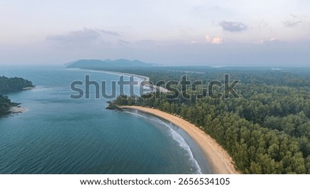 This is a beautiful sunset image over the ocean, with a small island or landmass in the foreground. The golden hues of the sun blend seamlessly into the sky, creating a peaceful and serene atmosphere