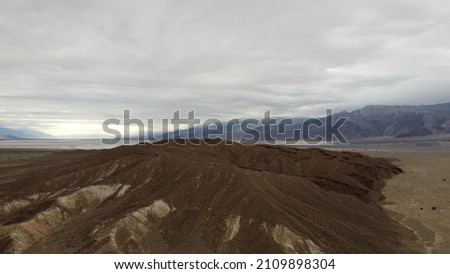 In this below-sea-level basin, steady drought and record summer heat make Death Valley a land of extremes. Yet, each extreme has a striking contrast. Towering peaks are frosted with winter snow.
