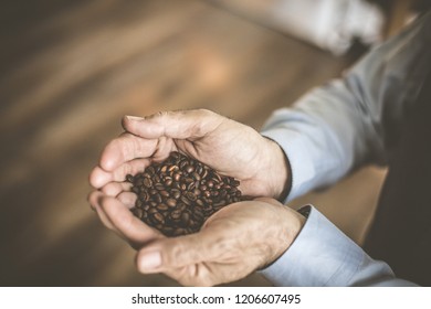 This is black treasure. Senior man holding powder coffee in hands. Close up. - Shutterstock ID 1206607495