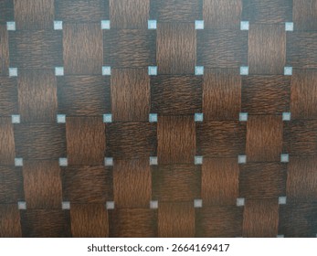 This board features a decorative surface with a woven or braided pattern that mimics the appearance of wood grains. The pattern consists of interlocking rectangular segments, creating a textured visua
