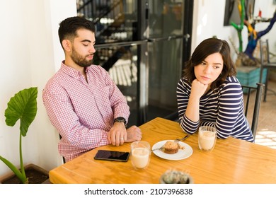 This Is So Boring. Young Woman And Man On A Failed Blind Date Feeling Bored At The Cafe