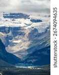 This breathtaking image captures a panoramic view of **Lake Louise**, a vibrant turquoise glacial lake, nestled deep within the **Canadian Rockies** in **Banff National Park, Alberta**.