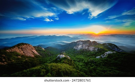 This breathtaking image captures the stunning beauty of a mountainous landscape at sunset. The sky is painted with vibrant colors ranging from deep blues to fiery oranges. - Powered by Shutterstock