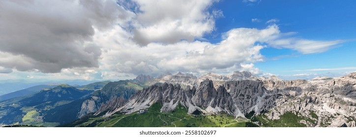 This breathtaking panoramic photograph captures the heart of the Dolomites, showcasing their jagged peaks and verdant valleys under a dramatic sky. - Powered by Shutterstock