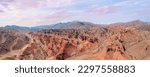 This breathtaking panoramic view captures the stunning red rock canyon nestled in the mountains. The vibrant shades of the rocks and  awe sky