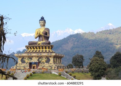 This Buddha Statue Is Situated In Buddha Park In North Sikkim District Of India. Plush Landscape, Ice-clad Mountains In Background And Giant Statue Make This Place A Tourist Attraction.