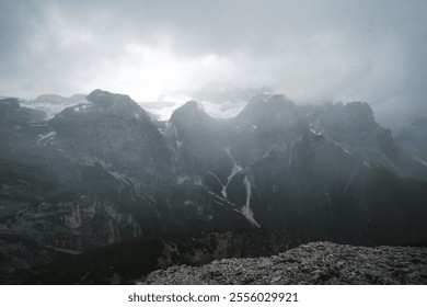 This is a captivating black and white photograph depicting a majestic and rugged mountain range, showcasing its natural beauty and grandeur - Powered by Shutterstock