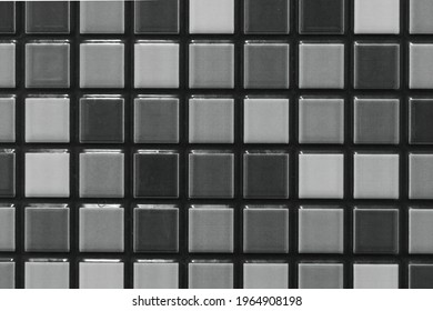 This captivating mosaic tile pattern seamlessly combines shades of black, grey, and white to create a stunning visual masterpiece. Each tile is meticulously crafted to form a harmonious arrangement, s