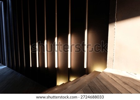 This captivating shot features a rhythmic sequence of timber frames, masterfully illuminated by linear lighting to create a profound sense of depth and perspective."