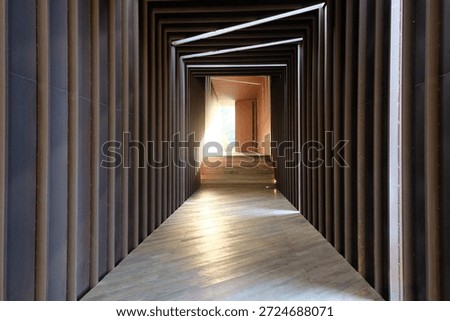 This captivating shot features a rhythmic sequence of timber frames, masterfully illuminated by linear lighting to create a profound sense of depth and perspective."