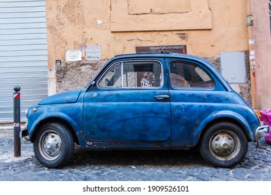 This car is a classic icon of Italian style of car design, with this car parked down a side road in Rome's city centre with rubbish behind it. - Powered by Shutterstock