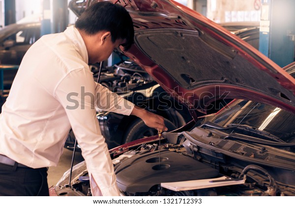 This career man\
saleman business inspection writing note on notepad or book, paper\
with car blurry background.for transport automobile automotive\
Illustrative editorial\
image