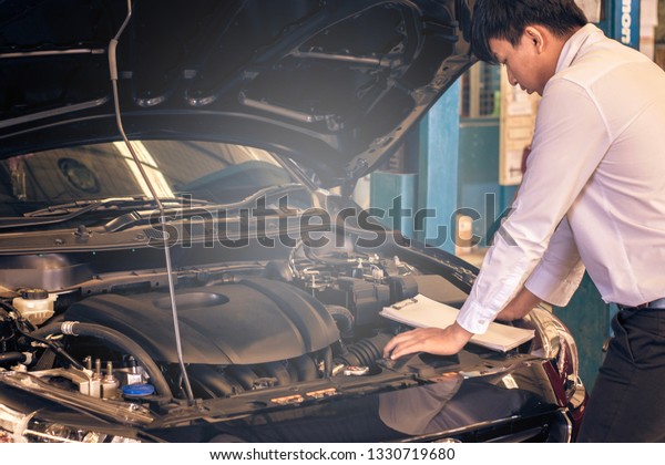 This career man\
saleman business inspection writing note on notepad or book, paper\
with car blurry background.for transport automobile automotive\
Illustrative editorial\
image