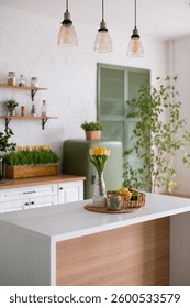 This charming kitchen features vibrant tulips and colorful fresh fruits, creating a refreshing and inviting atmosphere