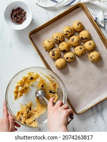 This Is A Chocolate Choco Chip Cookie Dough In A Bowl Shaped Round Using An Ice Cream Scoop On A Baking Sheet 