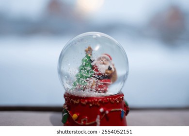 This classic Christmas snow globe features Santa and a festive tree, adding charm and joy to holiday decor - Powered by Shutterstock