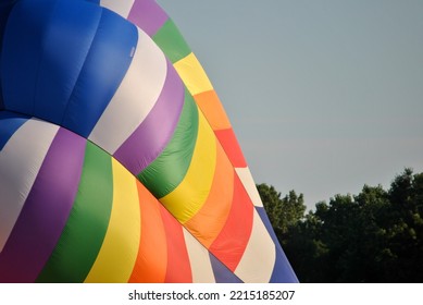 This Is A Close Up Picture Of A Hot Air Ballon, That Is Slowly Inflating On The Ground.