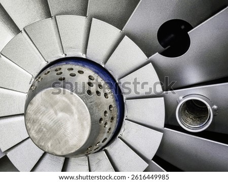This close-up captures the complexity of an aircraft engine turbine component, highlighting the precision engineering involved. The metallic structure reveals blades, housing, and airflow passages.