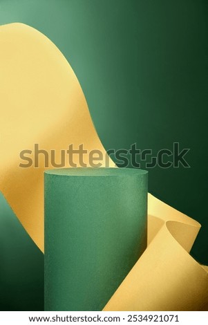 This close-up image of a round, softly textured green podium with a green backdrop and elegantly curved yellow sheet framing it is ideal for product displays or branding.