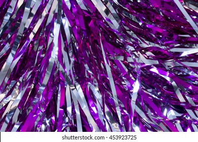 This is a closeup photograph of Cheerleader silver and purple pom poms 