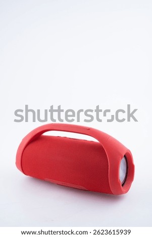 This compact red wireless Bluetooth speaker offers high quality sound and portability, perfect for outdoor use.
