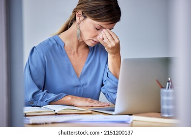 This day has been so stressfull. Shot of a businesswoman experiencing a headache at work. - Shutterstock ID 2151200137