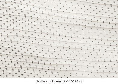This delicate fabric features a repeating pattern of polka dots, perfect for backgrounds or design elements