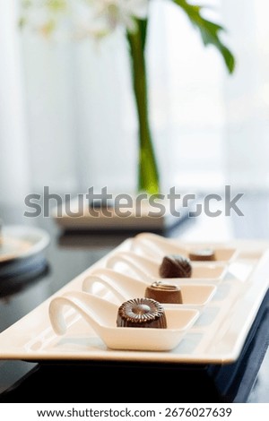 This describes the practice of offering chocolates as complimentary gifts or amenities to hotel guests. This gesture is a key part of hospitality.