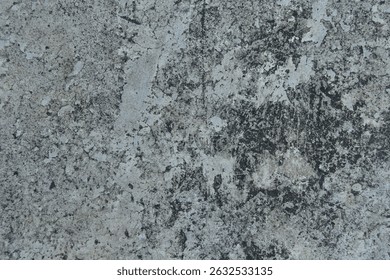 This detailed close-up photo captures the natural texture and weathered surface of an aged concrete or stone wall. The intricate pattern of cracks, weathering, and color variations in shades of grey 