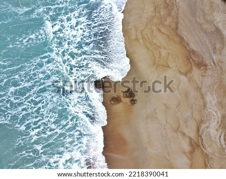 Similar – Luftaufnahme Panoramadrohne Blick auf den blauen Ozean Wellen, die am Sandstrand in Portugal erdrücken.