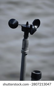 This device is a cup anemometer, a meteorological instrument used to measure wind speed.