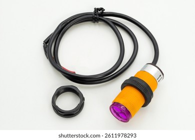 This device features an orange and silver body, designed for various industrial automation tasks with reliable detection capabilities.