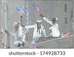 This is a digitally created image of a ticker tape parade in New York, New York. It was the Desert Storm Victory parade with three sailors celebrating with waving American flags in their hands.