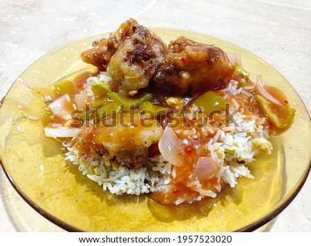 This dish is known as Cauliflower Manchurian. Rice with Manchurian and Fried Cauliflower topping. Picture was taken on 17th April 2021 at 6:40 PM PST in Rawalpindi, Pakistan