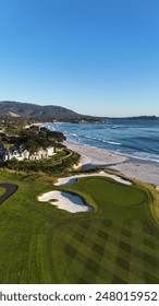 This drone image captures Pebble Beach Golf Course and Carmel-by-the-Sea. Beautiful image for golf lovers and scenic enthusiasts. This image was taken by a drone at golden hour on the central coast.