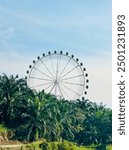 This dynamic image captures the thrill and excitement of a vibrant amusement park featuring a towering Ferris wheel and a winding luge track stands majestically against the sky offering panoramic view