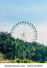 This dynamic image captures the thrill and excitement of a vibrant amusement park featuring a towering Ferris wheel and a winding luge track stands majestically against the sky offering panoramic view