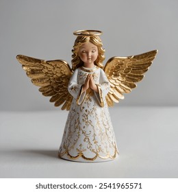 This elegant Christmas angel figurine features delicate golden wings, symbolizing peace and grace.  - Powered by Shutterstock